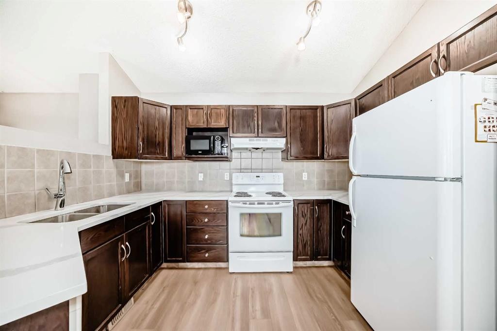 231 Saddlebrook Way Ne, Calgary, AB - Indoor Photo Showing Kitchen With Double Sink