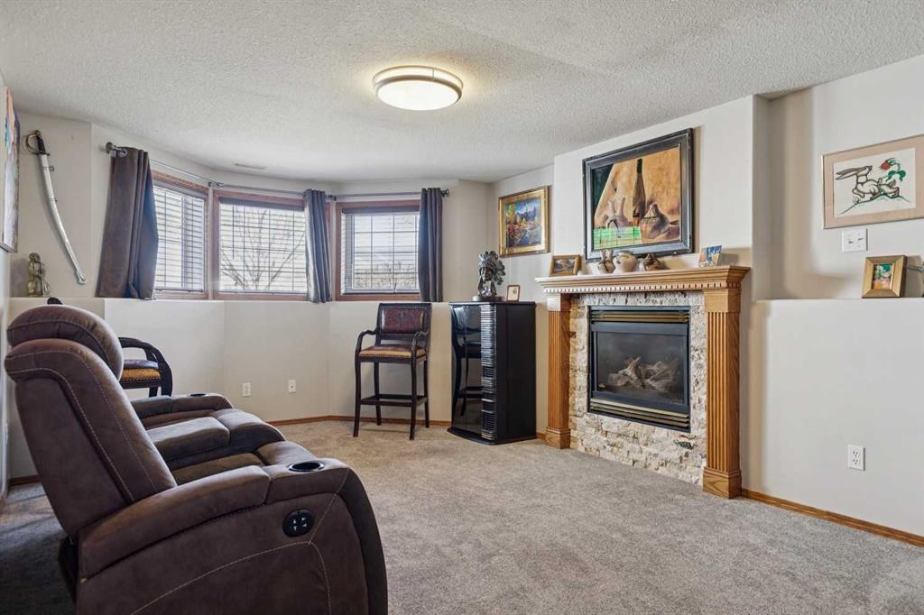28 Westpoint Drive, Didsbury, AB - Indoor Photo Showing Living Room With Fireplace