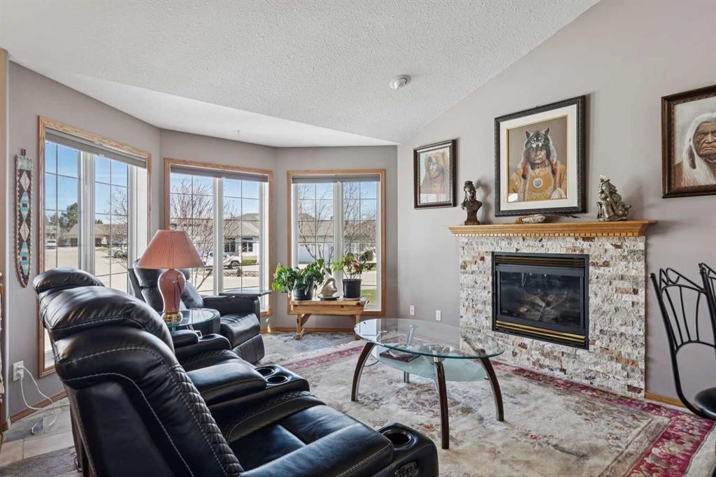 28 Westpoint Drive, Didsbury, AB - Indoor Photo Showing Living Room With Fireplace