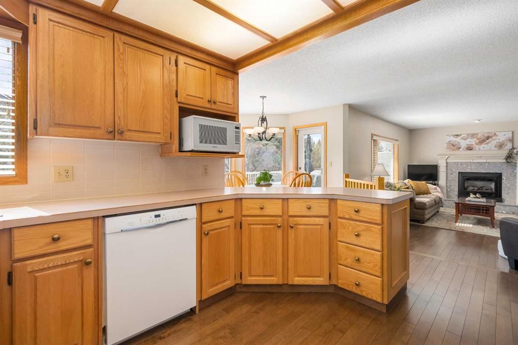 27 Hawkstone Close Nw, Calgary, AB - Indoor Photo Showing Kitchen With Fireplace