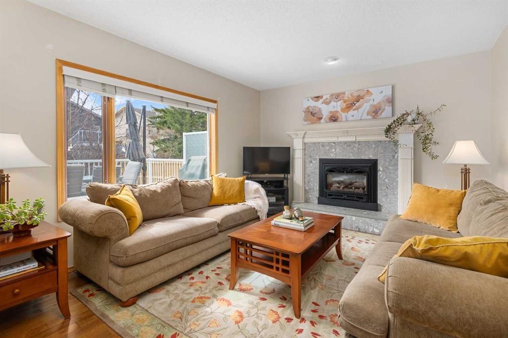 27 Hawkstone Close Nw, Calgary, AB - Indoor Photo Showing Living Room With Fireplace
