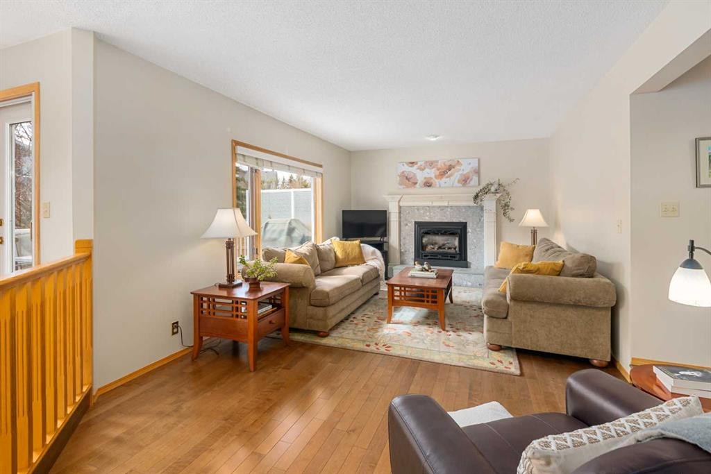 27 Hawkstone Close Nw, Calgary, AB - Indoor Photo Showing Living Room With Fireplace
