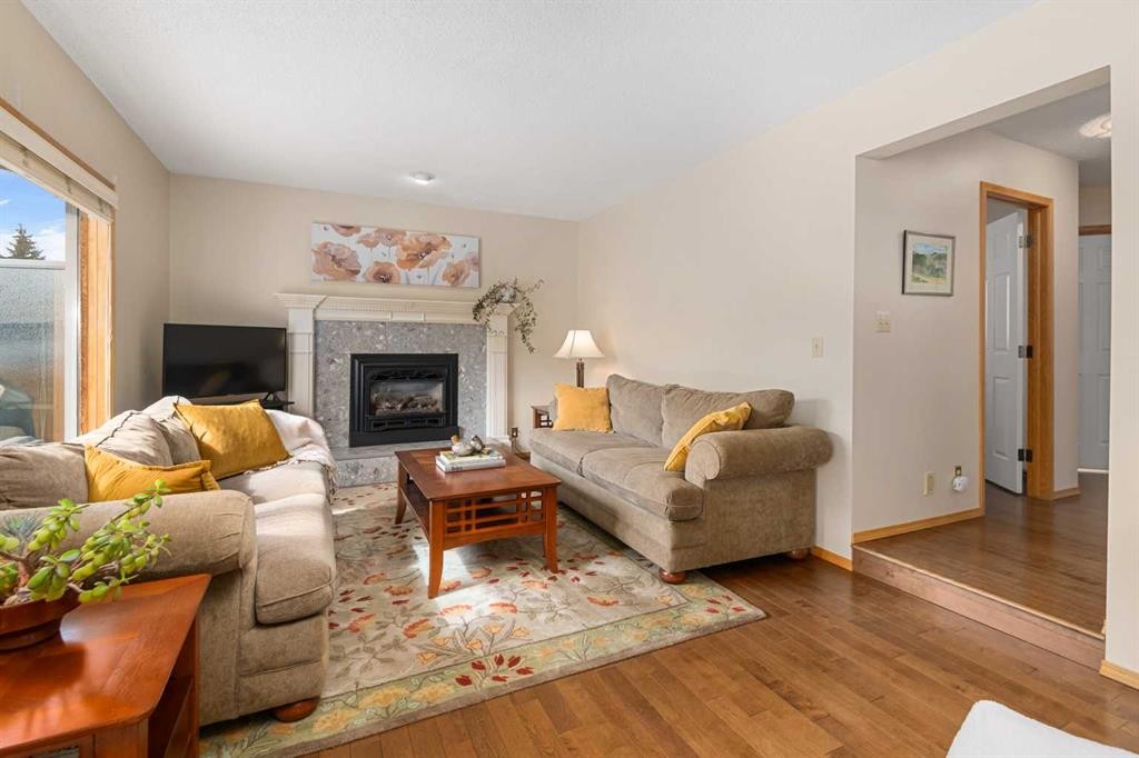 27 Hawkstone Close Nw, Calgary, AB - Indoor Photo Showing Living Room With Fireplace