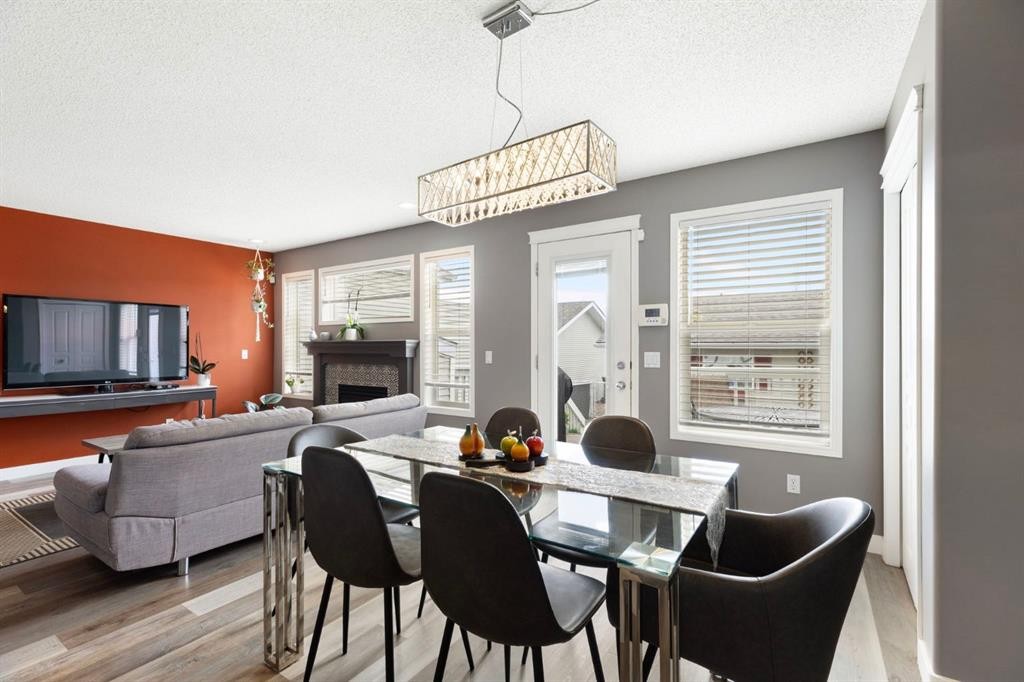 18 West Springs Gate Sw, Calgary, AB - Indoor Photo Showing Dining Room With Fireplace