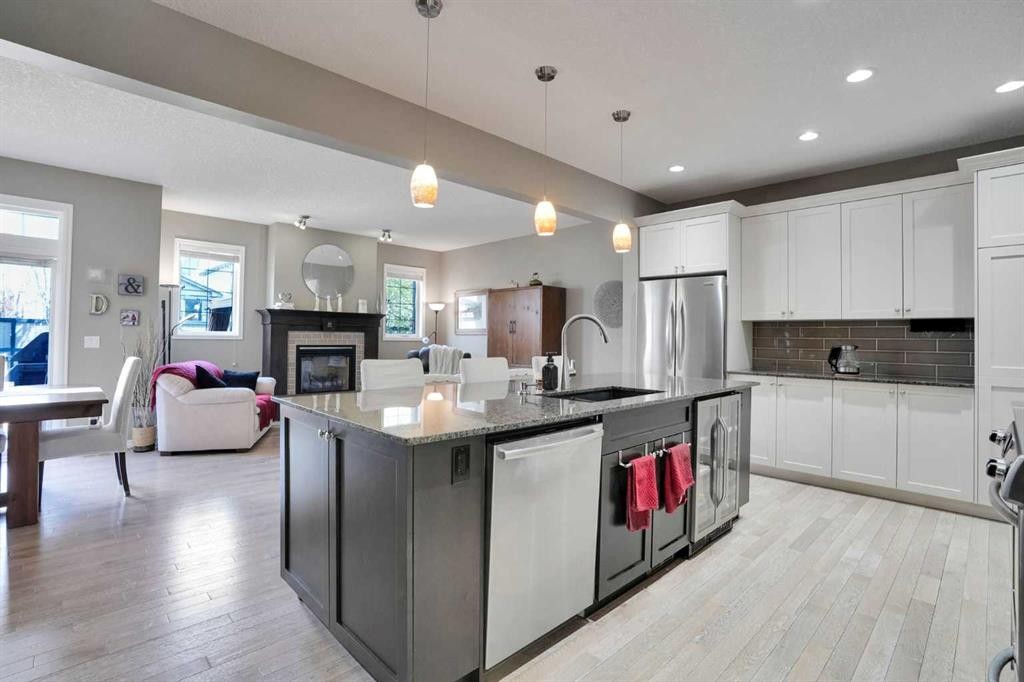 109 Cranleigh Place Se, Calgary, AB - Indoor Photo Showing Kitchen With Fireplace With Stainless Steel Kitchen With Upgraded Kitchen