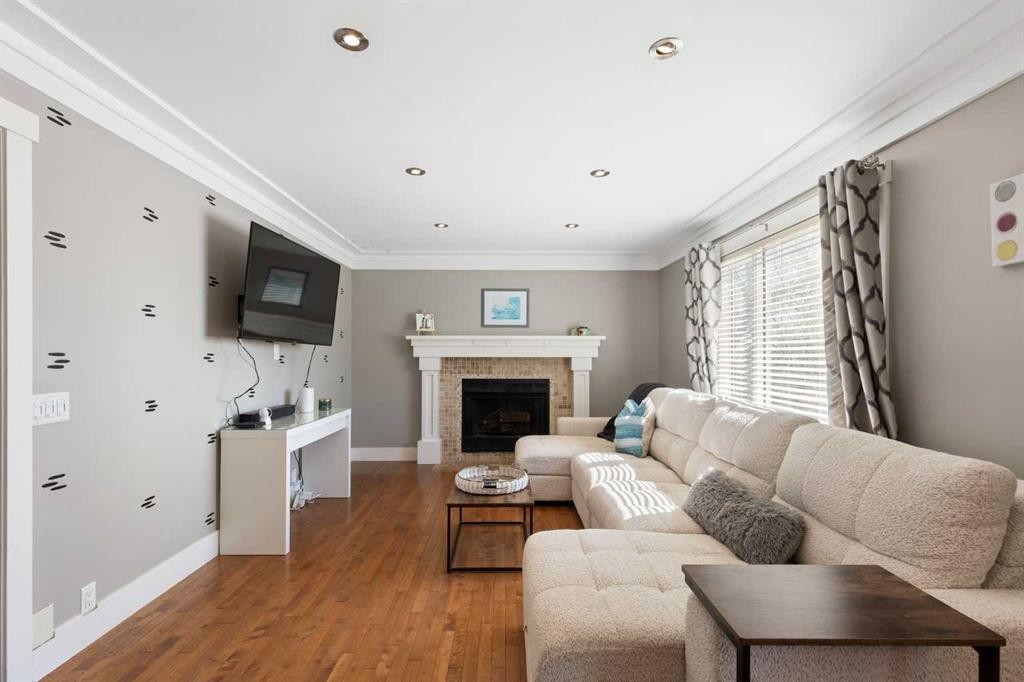 1030 Mckenzie Lake Bay Se, Calgary, AB - Indoor Photo Showing Living Room With Fireplace