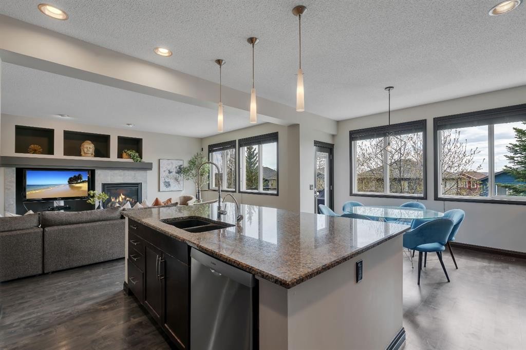 55 Evanspark Circle Nw, Calgary, AB - Indoor Photo Showing Kitchen With Fireplace With Double Sink