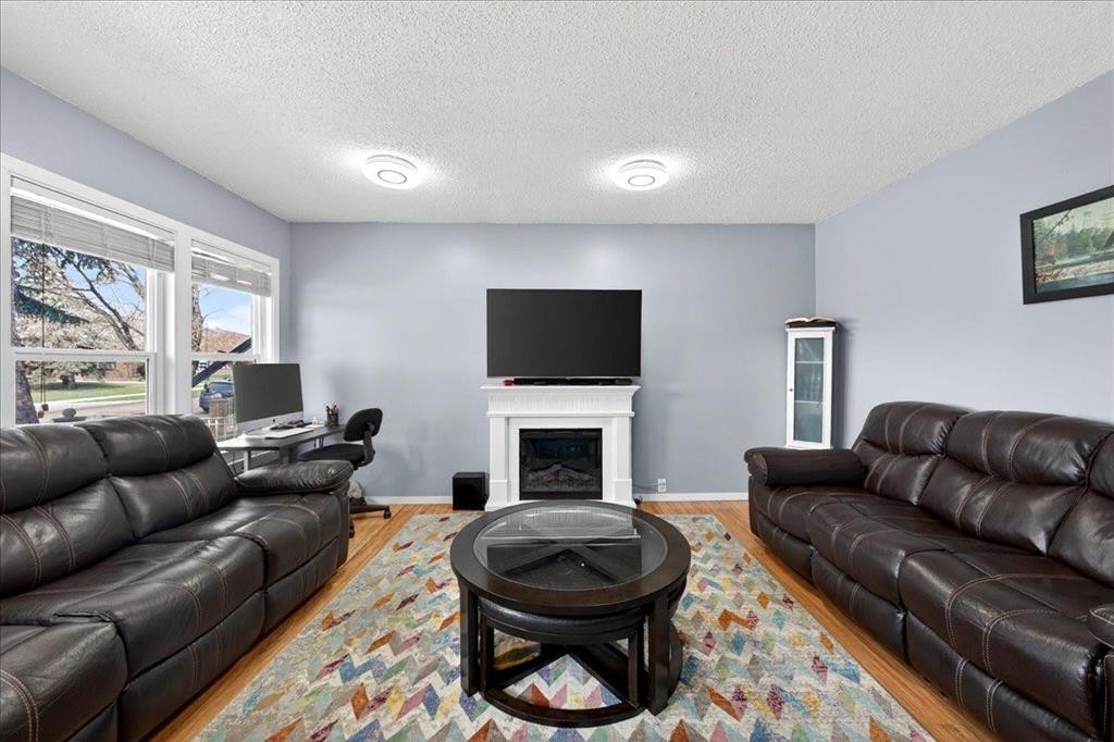 3620 28 Street Se, Calgary, AB - Indoor Photo Showing Living Room With Fireplace