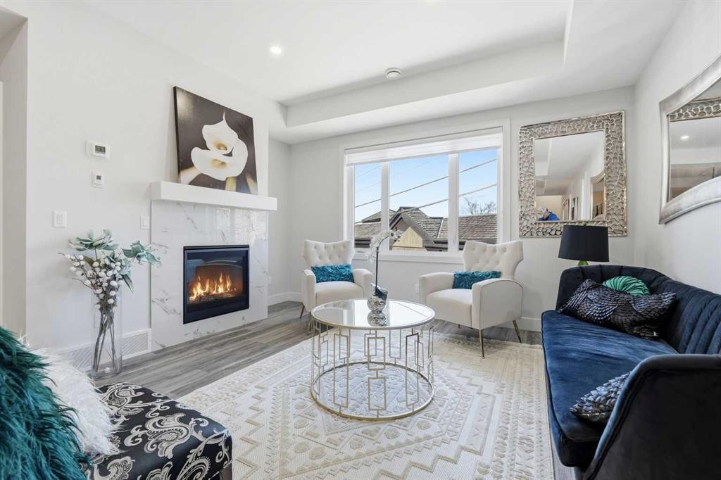 2-2635 1 Avenue Nw, Calgary, AB - Indoor Photo Showing Living Room With Fireplace