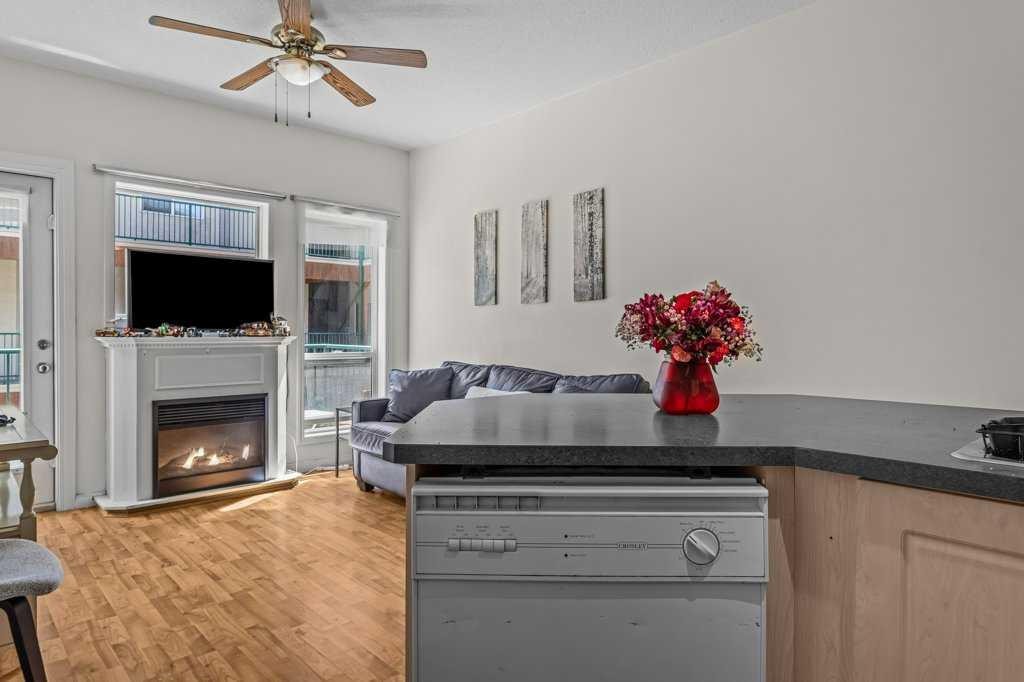 211-176 Kananaskis Way, Canmore, AB - Indoor Photo Showing Other Room With Fireplace