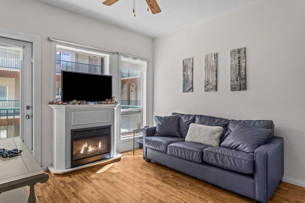 211-176 Kananaskis Way, Canmore, AB - Indoor Photo Showing Living Room With Fireplace