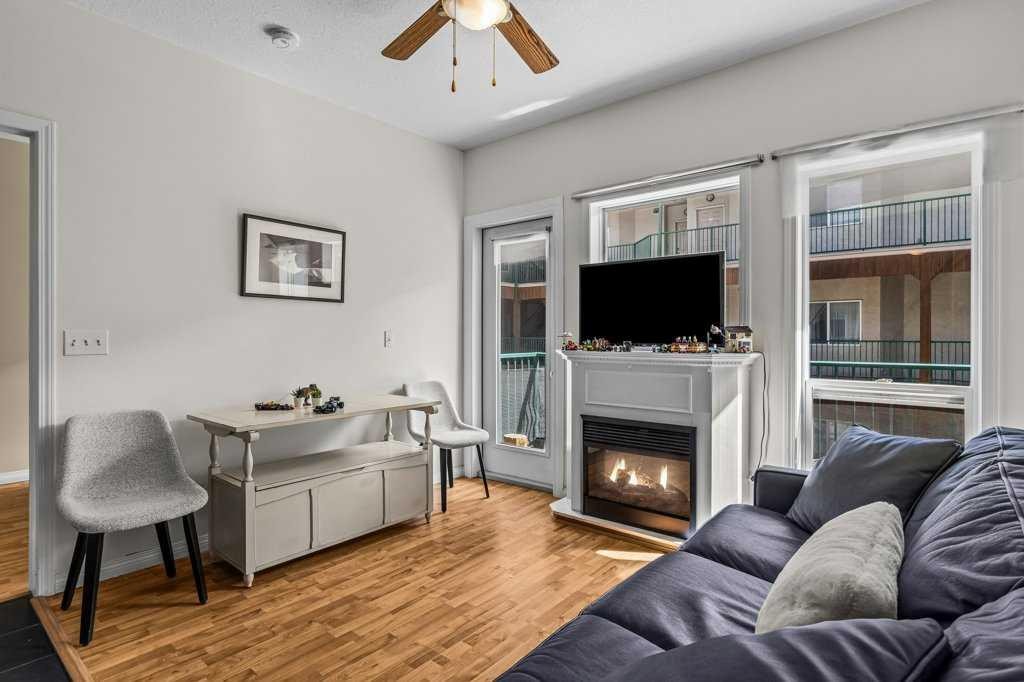 211-176 Kananaskis Way, Canmore, AB - Indoor Photo Showing Living Room With Fireplace