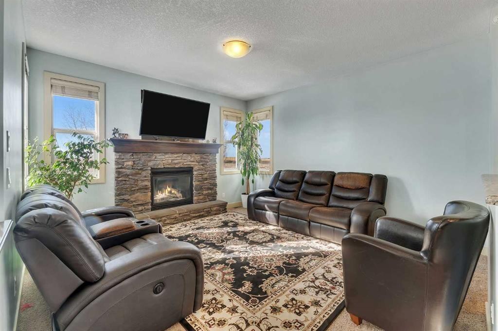 156 Bishop Crescent Nw, Langdon, AB - Indoor Photo Showing Living Room With Fireplace