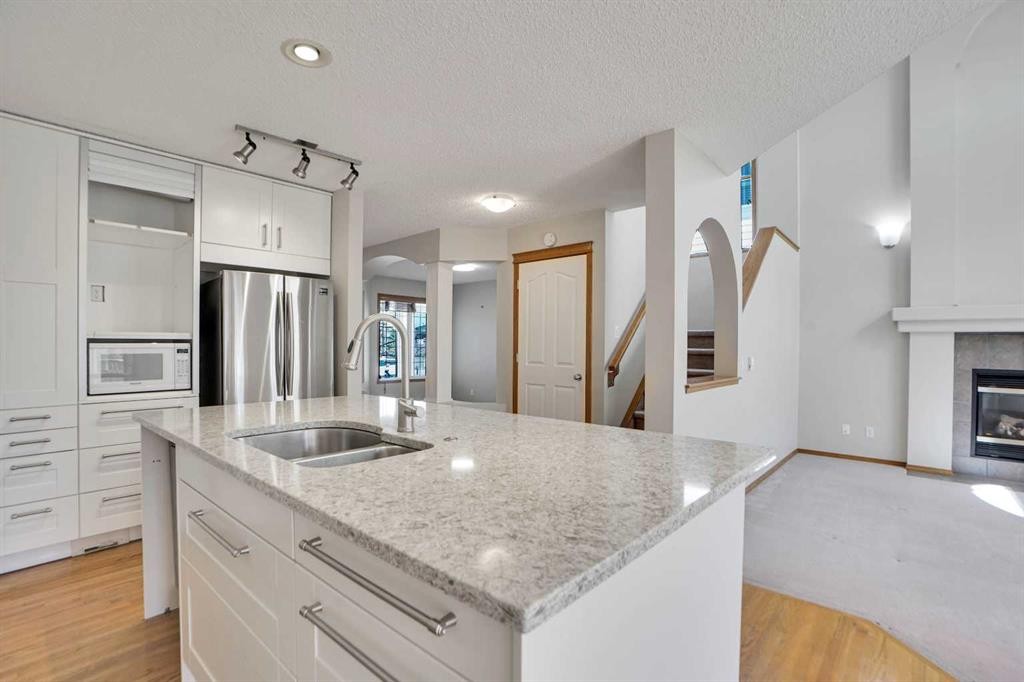 50 Cranfield Crescent Se, Calgary, AB - Indoor Photo Showing Kitchen With Fireplace With Double Sink With Upgraded Kitchen