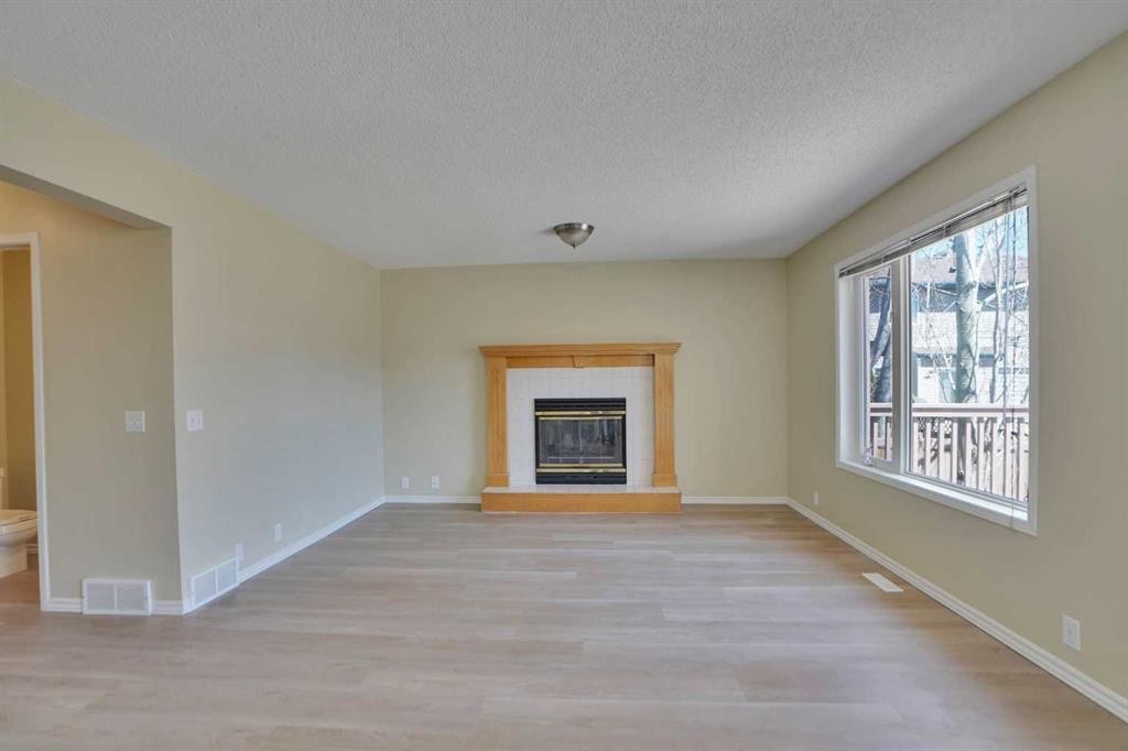 6 Somerset Close Sw, Calgary, AB - Indoor Photo Showing Living Room With Fireplace