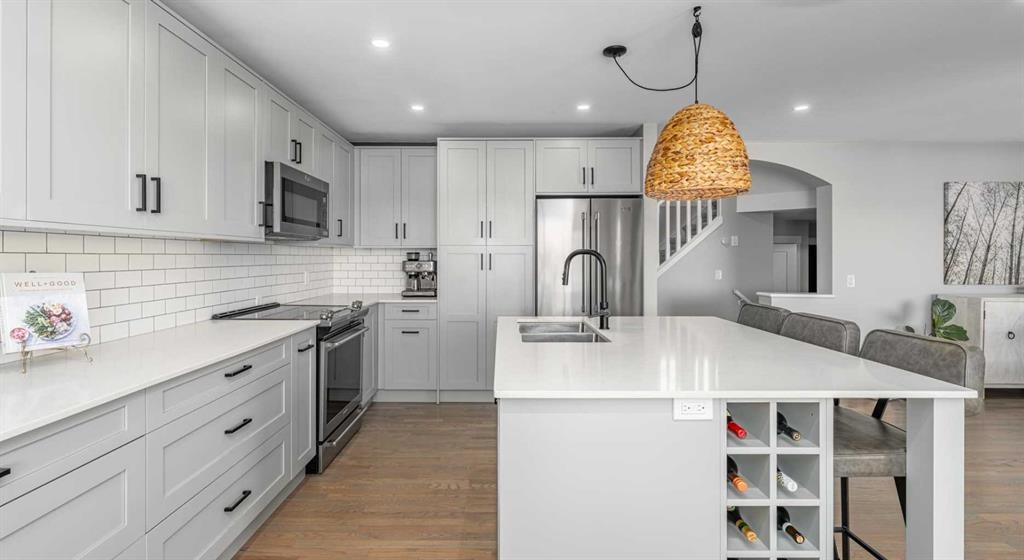 8 Sheep River Hill, Okotoks, AB - Indoor Photo Showing Kitchen With Stainless Steel Kitchen With Double Sink With Upgraded Kitchen