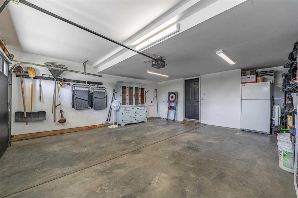 8 Sheep River Hill, Okotoks, AB - Indoor Photo Showing Garage