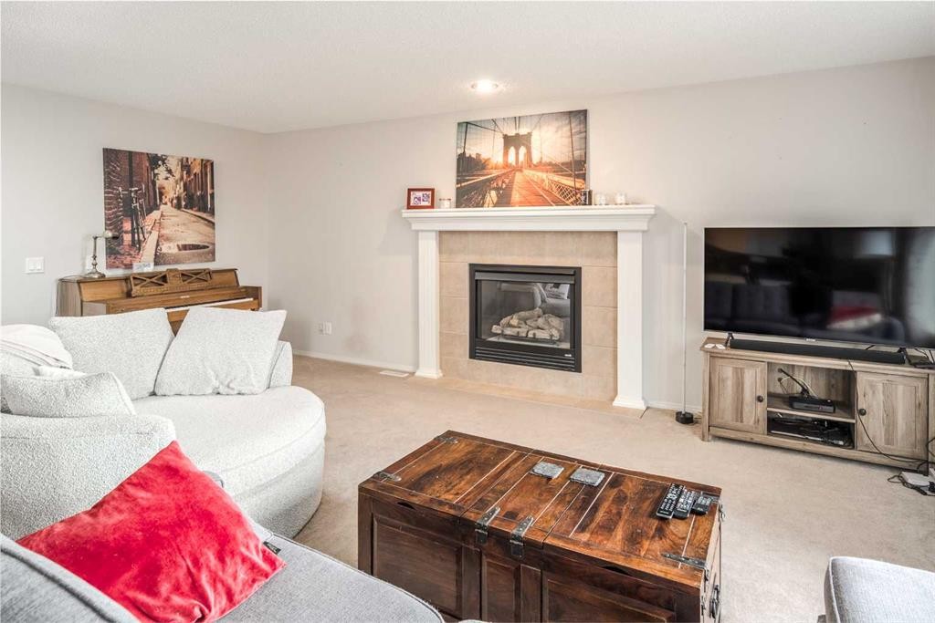 4 Springbank Bay Sw, Calgary, AB - Indoor Photo Showing Living Room With Fireplace