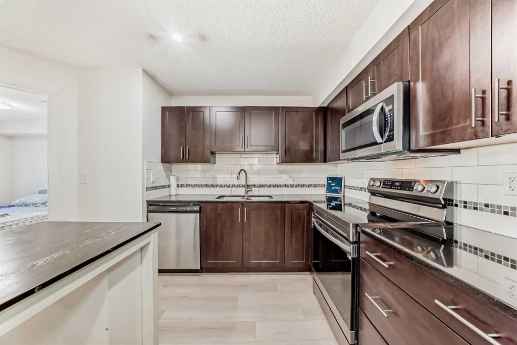 1312-755 Copperpond Boulevard Se, Calgary, AB - Indoor Photo Showing Kitchen With Double Sink With Upgraded Kitchen