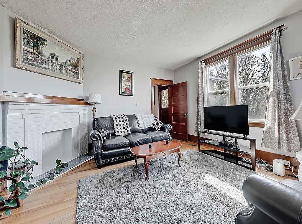 5136 54 Avenue, Stavely, AB - Indoor Photo Showing Living Room With Fireplace