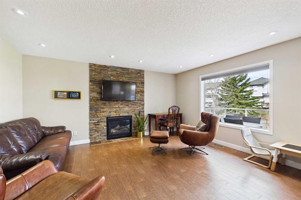149 Tuscany Ravine Bay Nw, Calgary, AB - Indoor Photo Showing Living Room With Fireplace