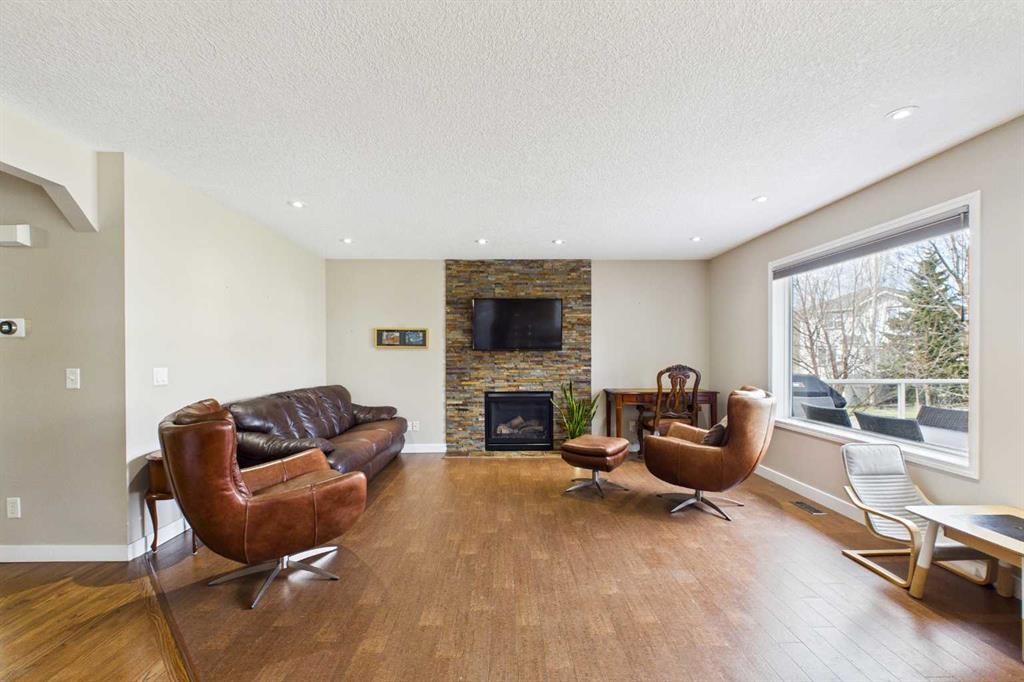 149 Tuscany Ravine Bay Nw, Calgary, AB - Indoor Photo Showing Living Room With Fireplace