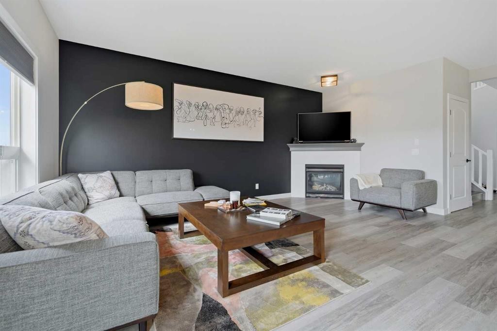 115 Everwoods Park Sw, Calgary, AB - Indoor Photo Showing Living Room With Fireplace