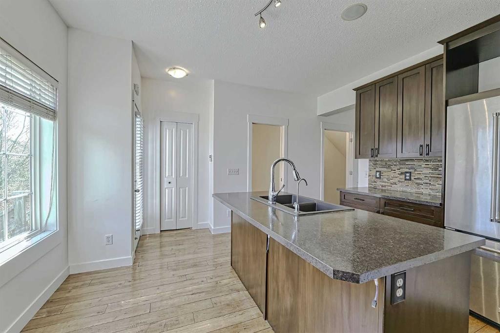 179 Rainbow Falls Drive, Chestermere, AB - Indoor Photo Showing Kitchen With Double Sink