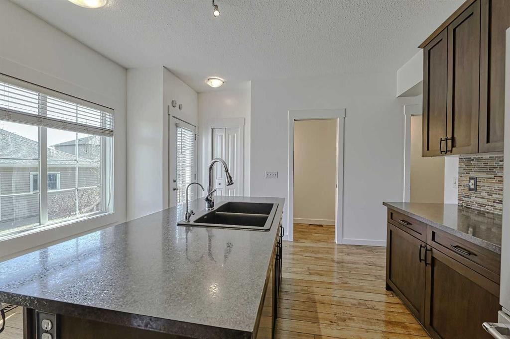 179 Rainbow Falls Drive, Chestermere, AB - Indoor Photo Showing Kitchen With Double Sink