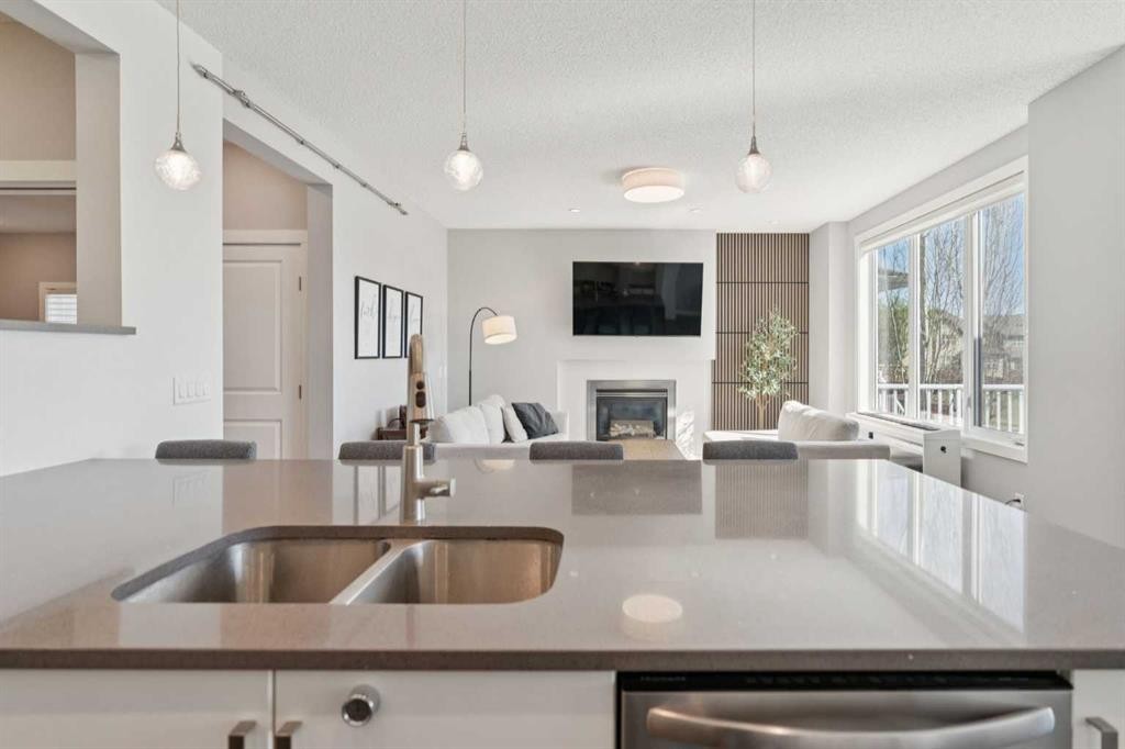 52 Mahogany Way Se, Calgary, AB - Indoor Photo Showing Kitchen With Fireplace With Double Sink