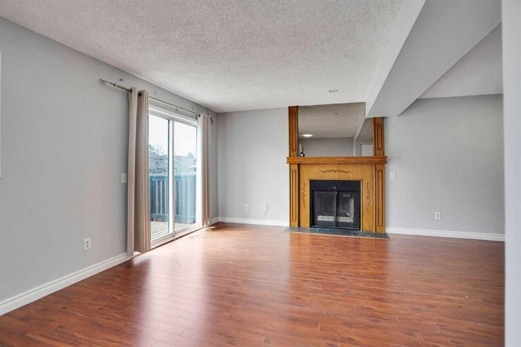 336 Whitworth Way Ne, Calgary, AB - Indoor Photo Showing Living Room With Fireplace