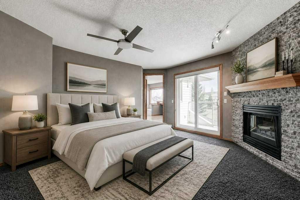 91 Valley Ridge Green Nw, Calgary, AB - Indoor Photo Showing Bedroom With Fireplace