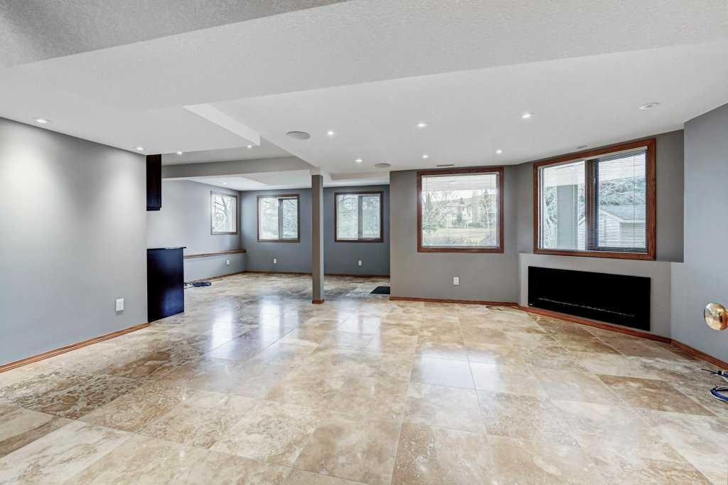 91 Valley Ridge Green Nw, Calgary, AB - Indoor Photo Showing Other Room With Fireplace