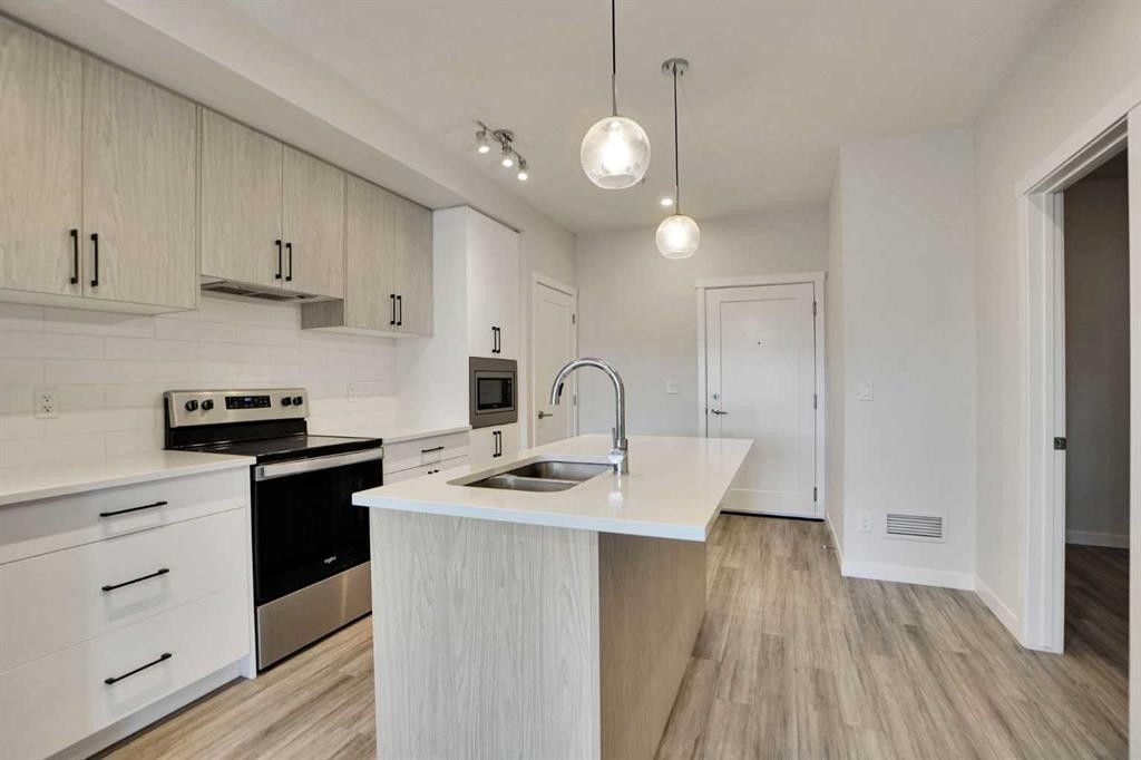 405-138 Sage Valley Common Nw, Calgary, AB - Indoor Photo Showing Kitchen With Double Sink With Upgraded Kitchen