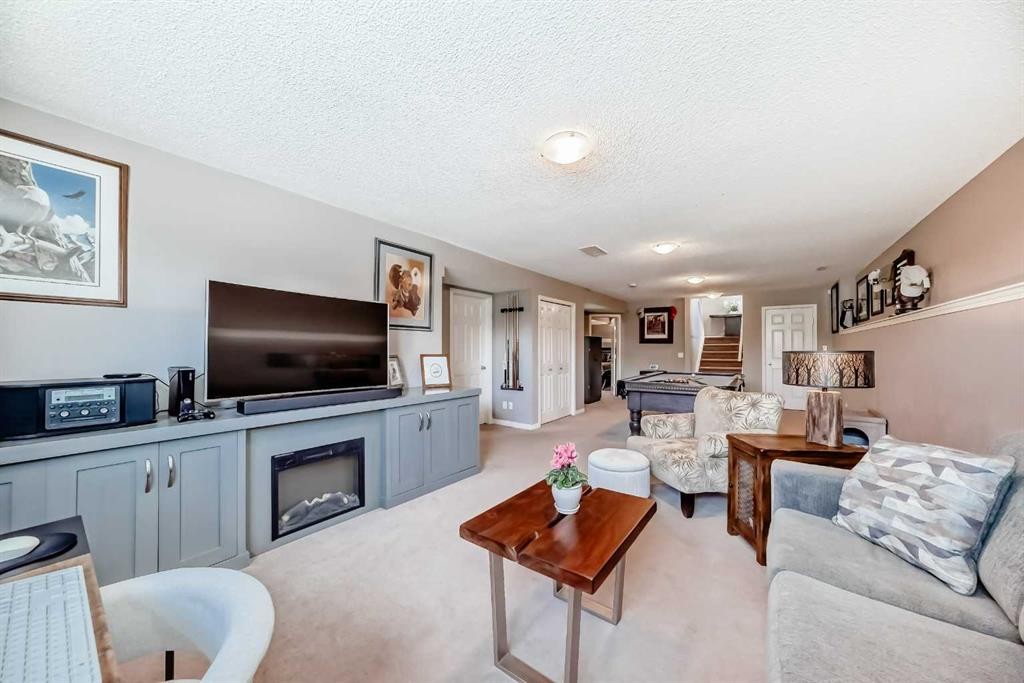 255 Copperfield Manor Se, Calgary, AB - Indoor Photo Showing Living Room With Fireplace