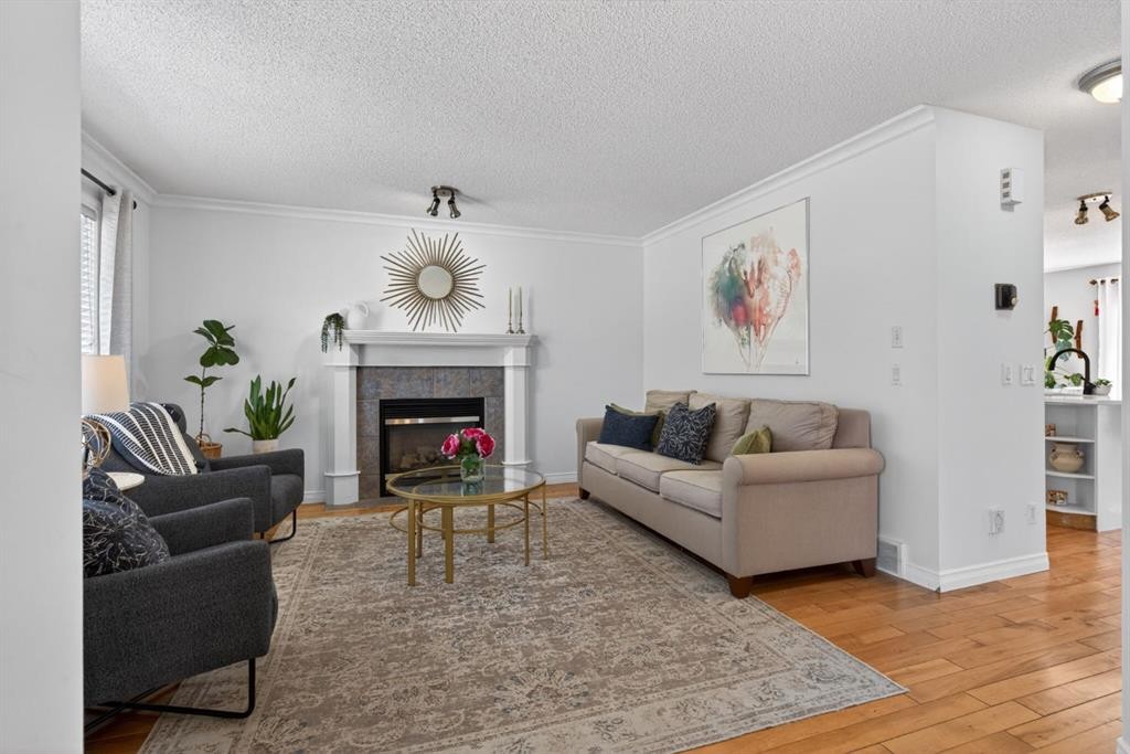 57 Bridlewood Manor Sw, Calgary, AB - Indoor Photo Showing Living Room With Fireplace