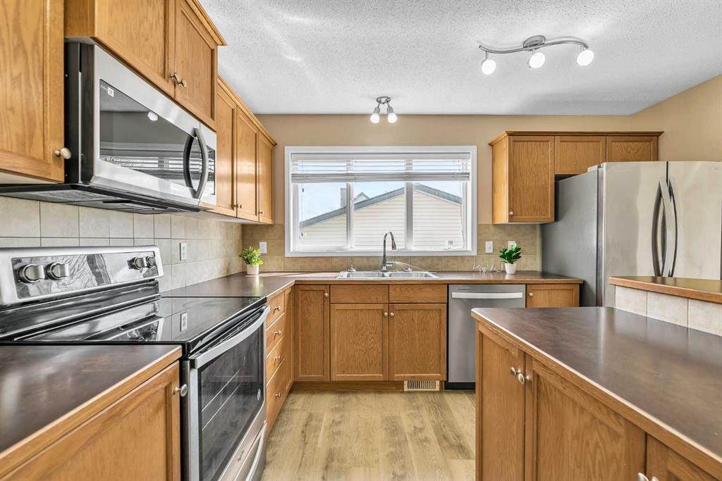 247 Evermeadow Avenue Sw, Calgary, AB - Indoor Photo Showing Kitchen With Stainless Steel Kitchen With Double Sink