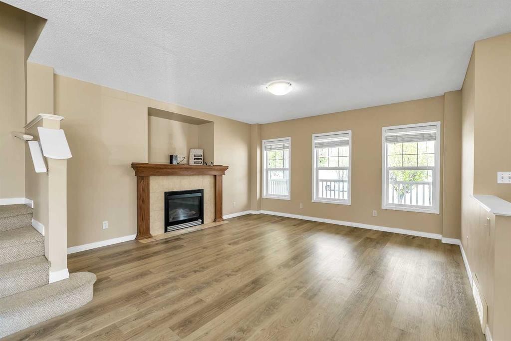 247 Evermeadow Avenue Sw, Calgary, AB - Indoor Photo Showing Living Room With Fireplace
