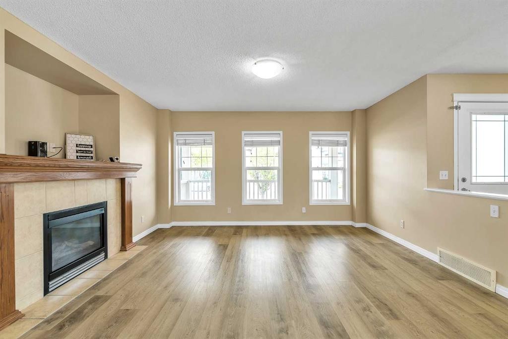 247 Evermeadow Avenue Sw, Calgary, AB - Indoor Photo Showing Living Room With Fireplace