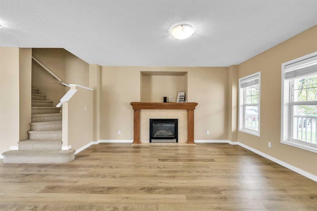 247 Evermeadow Avenue Sw, Calgary, AB - Indoor Photo Showing Living Room With Fireplace