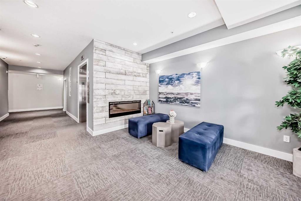1212-3727 Sage Hill Drive Nw, Calgary, AB - Indoor Photo Showing Other Room With Fireplace