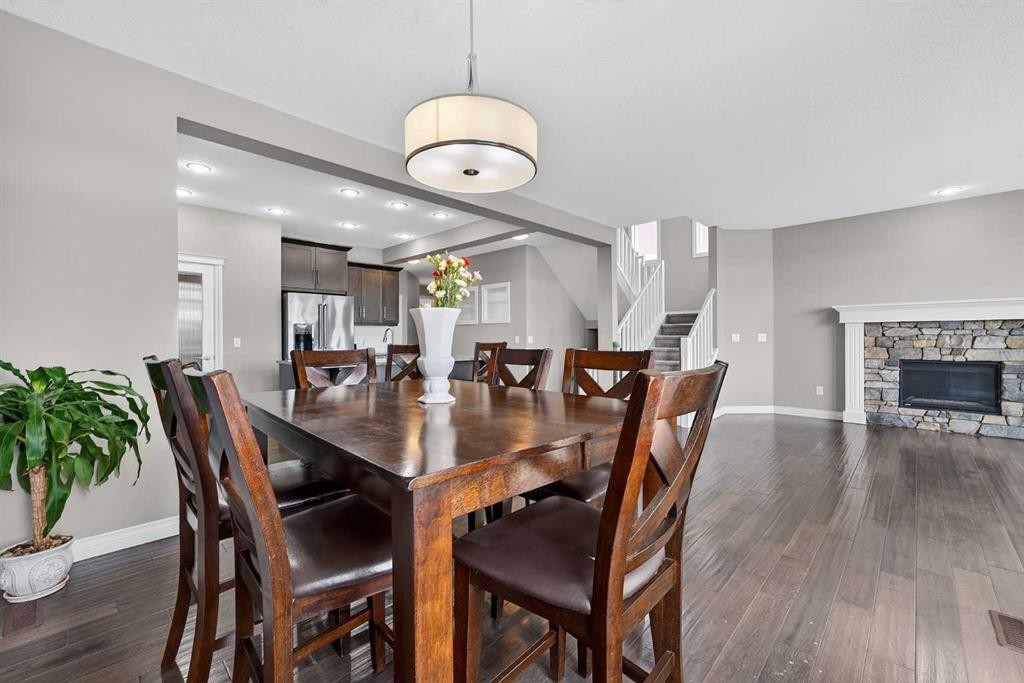 30 Evansborough View Nw, Calgary, AB - Indoor Photo Showing Dining Room With Fireplace