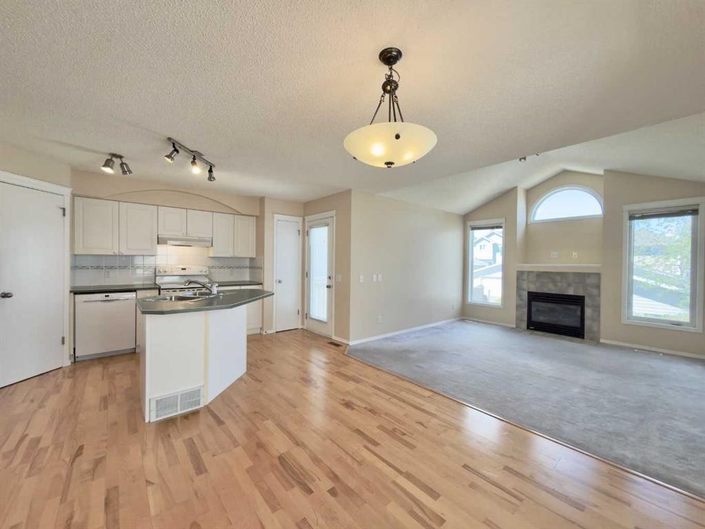 206 Tuscany Drive Nw, Calgary, AB - Indoor Photo Showing Other Room With Fireplace
