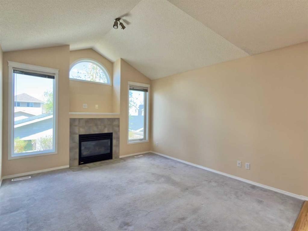206 Tuscany Drive Nw, Calgary, AB - Indoor Photo Showing Living Room With Fireplace