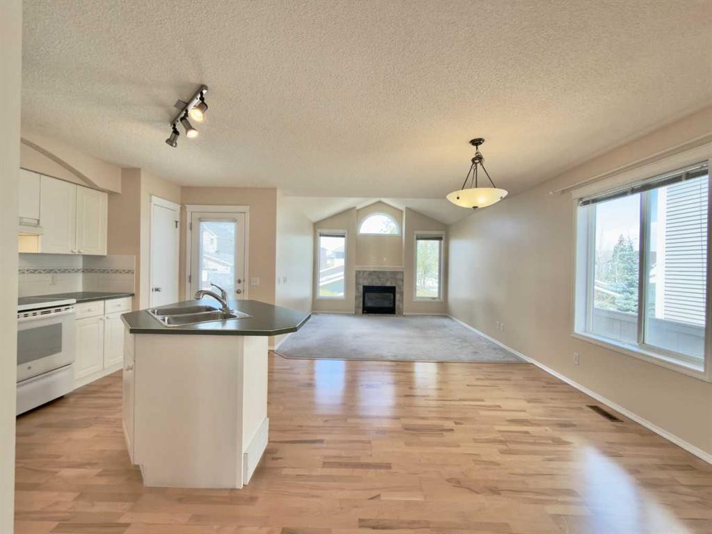 206 Tuscany Drive Nw, Calgary, AB - Indoor Photo Showing Kitchen With Fireplace With Double Sink