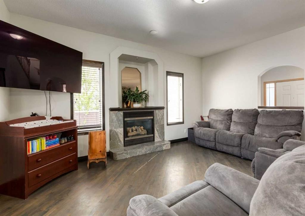 244 Stonegate Close Nw, Airdrie, AB - Indoor Photo Showing Living Room With Fireplace