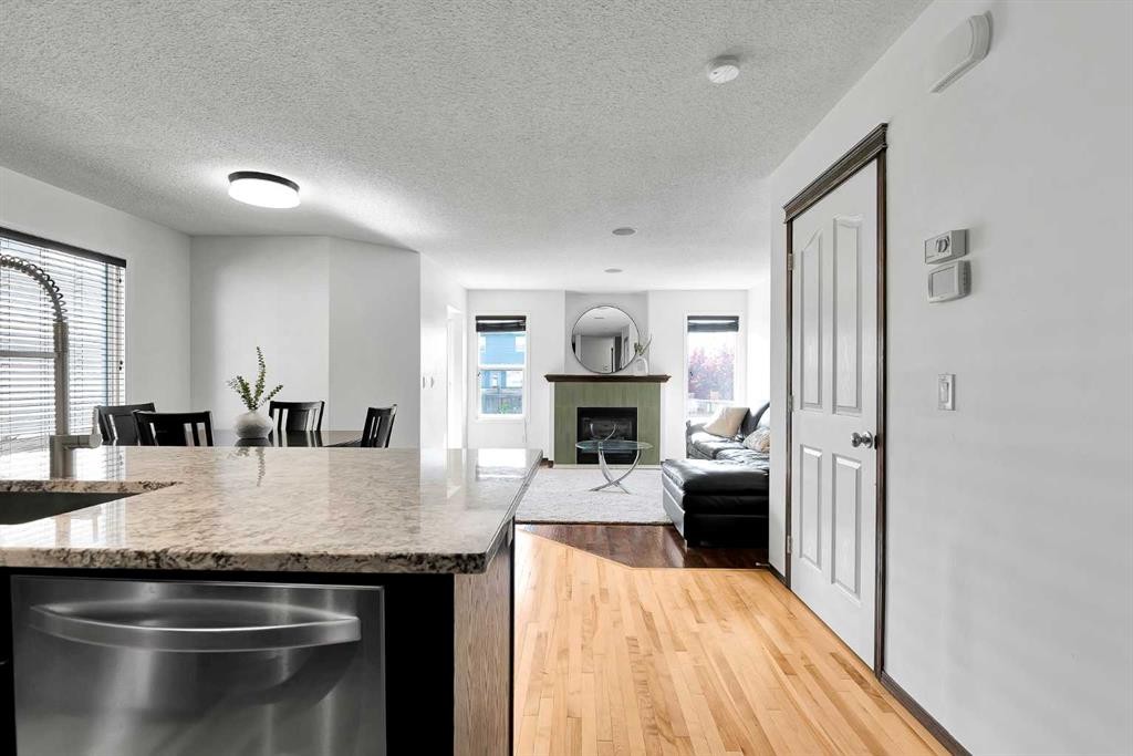 10 Autumn Green Se, Calgary, AB - Indoor Photo Showing Kitchen With Fireplace With Double Sink
