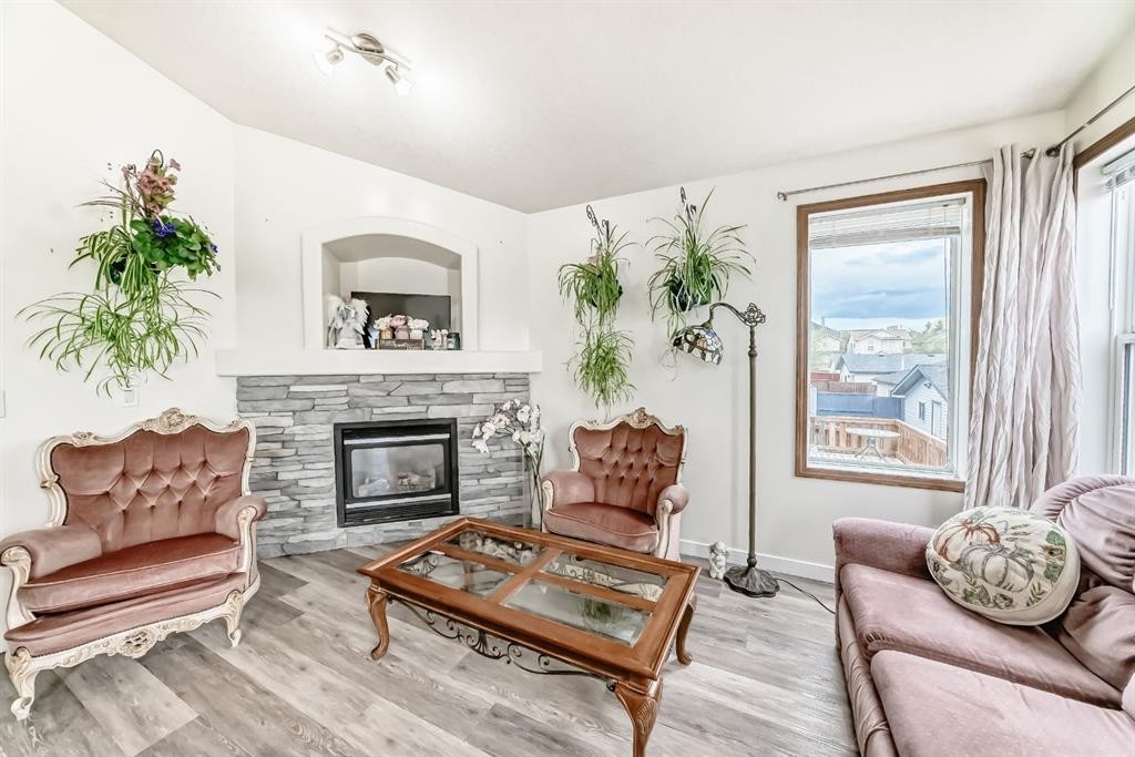 92 Everstone Rise Sw, Calgary, AB - Indoor Photo Showing Living Room With Fireplace