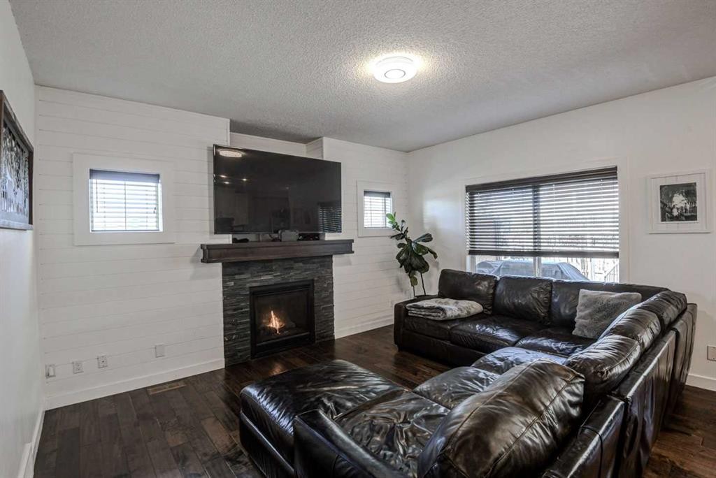 29 Drake Landing Loop, Okotoks, AB - Indoor Photo Showing Living Room With Fireplace