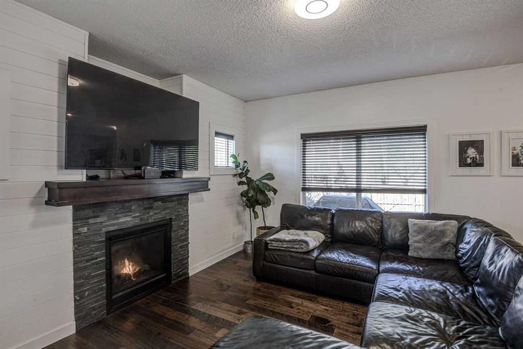 29 Drake Landing Loop, Okotoks, AB - Indoor Photo Showing Living Room With Fireplace